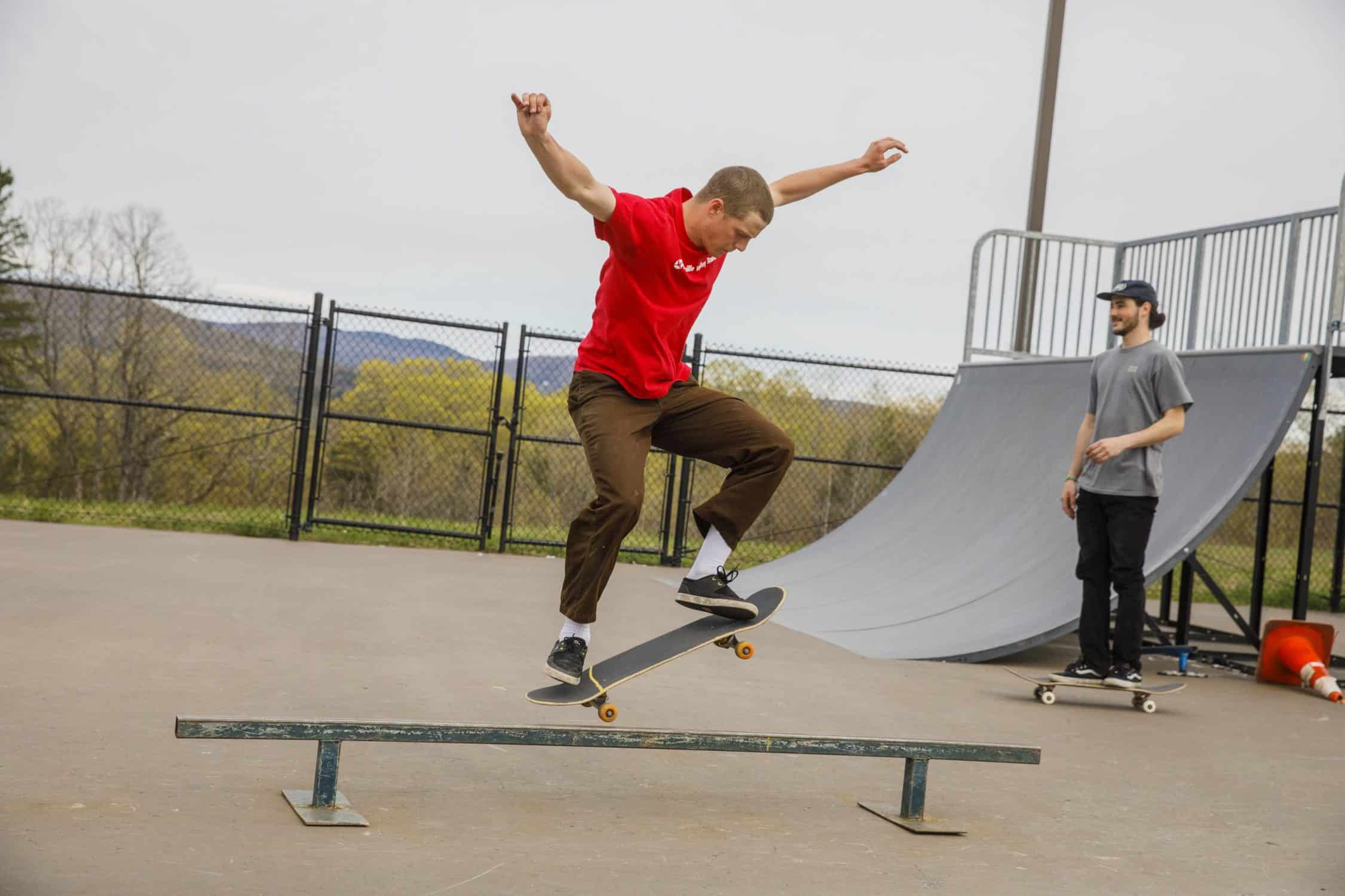 Student rides skateboard at the skate park on campus