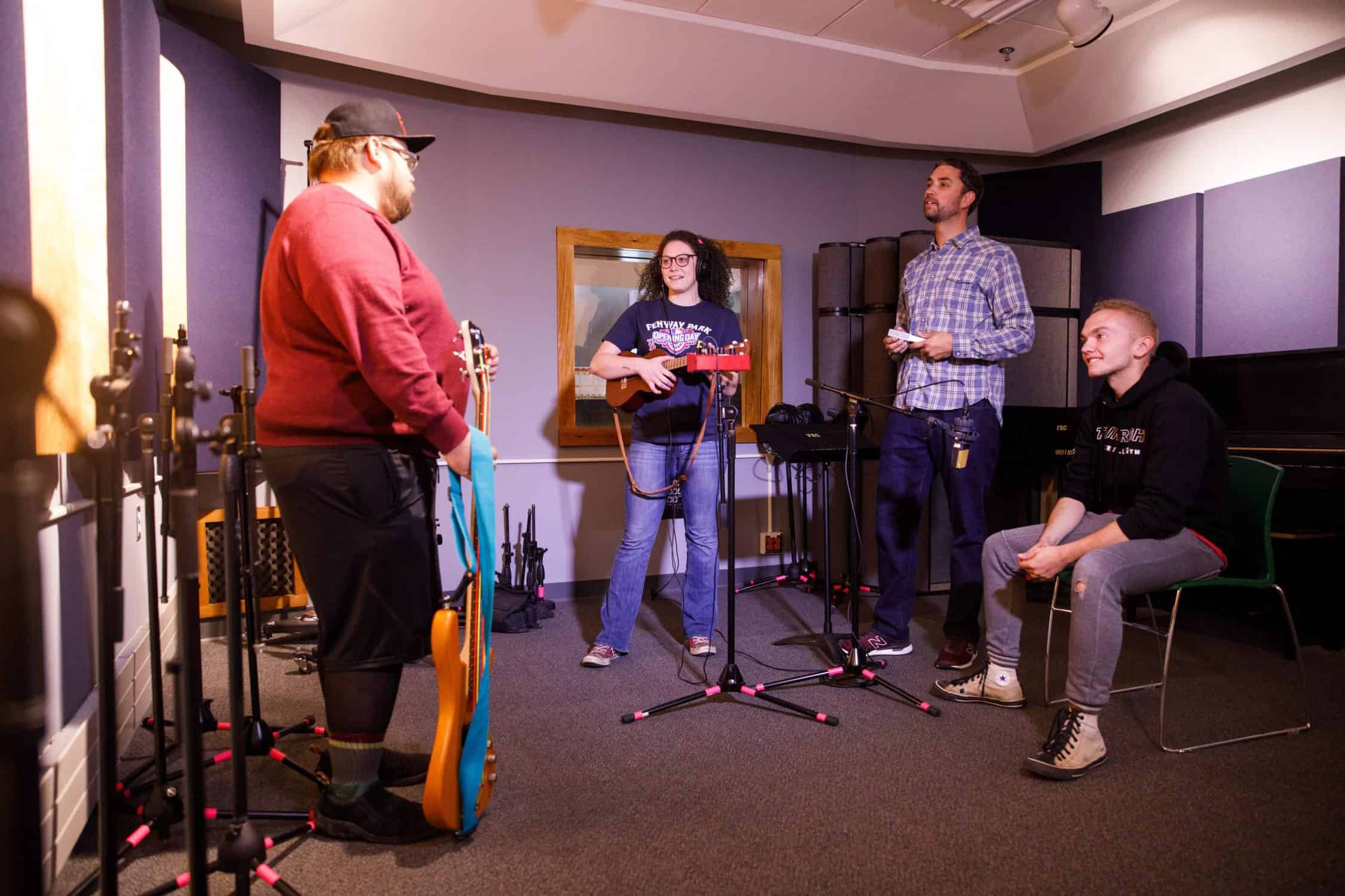 Students prepare to record music in the recording studio