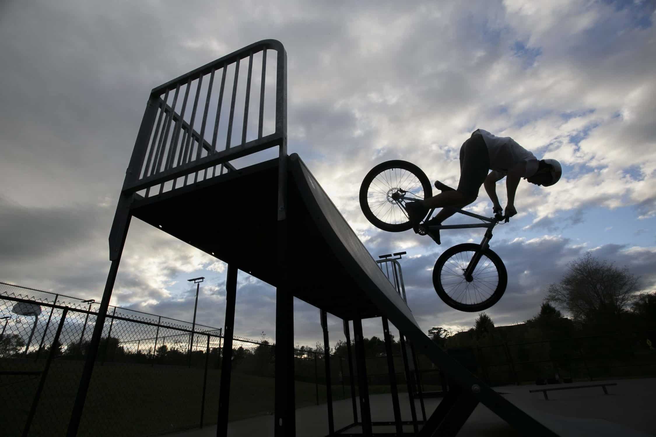Student rides his bike on a ramp at the skate park