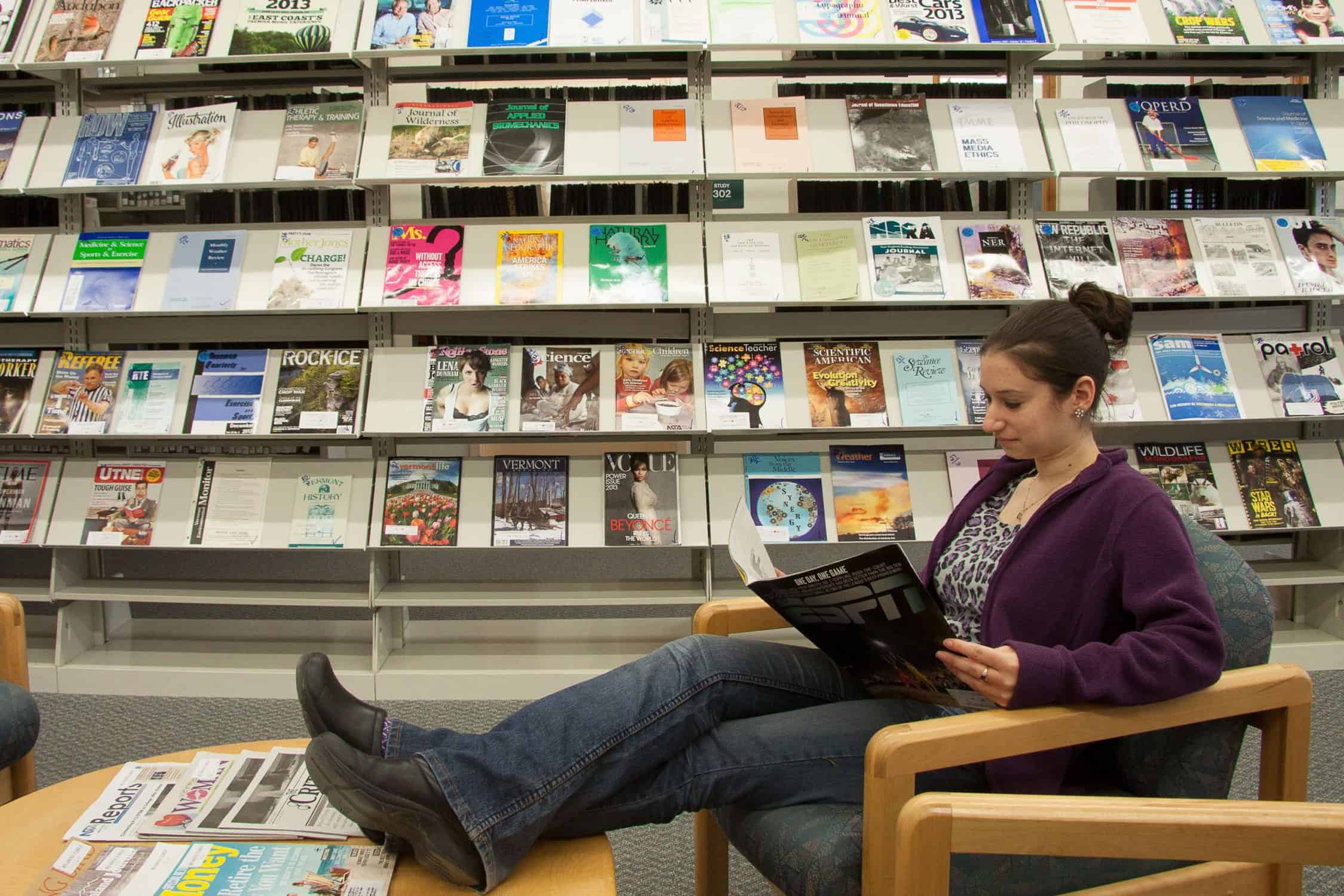 Person relaxes in a comfortable chair with a magazine